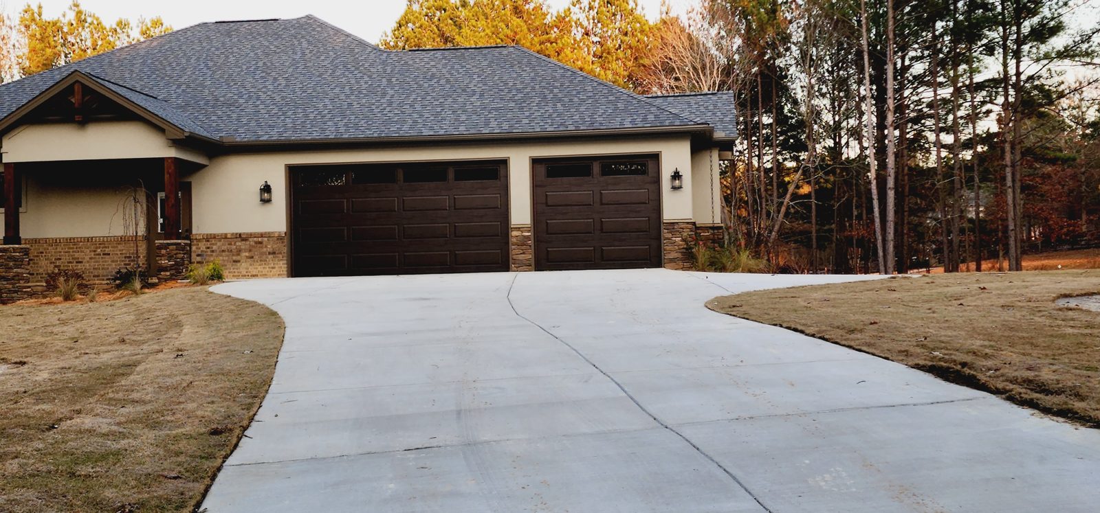 Wide gray garage door installation by Premier Access Solutions