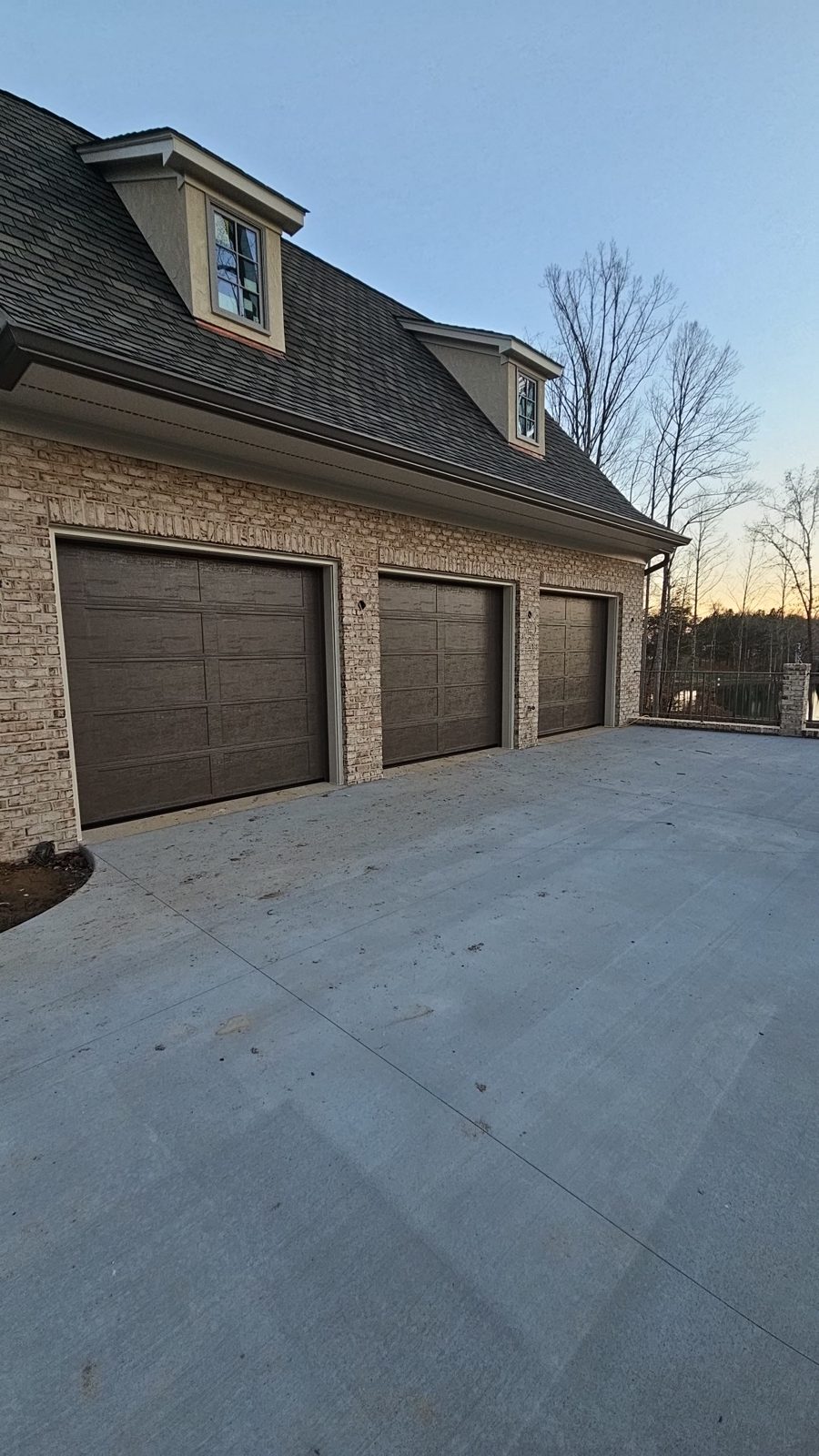 Gray garage door installed on a detached garage by Premier Access Solutions