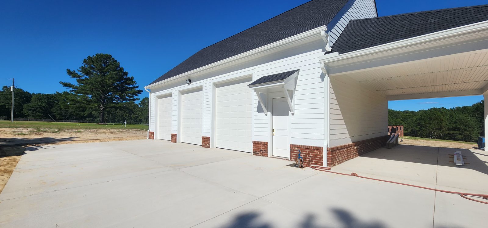 Two white garage doors installed on a home by Premier Access Solutions