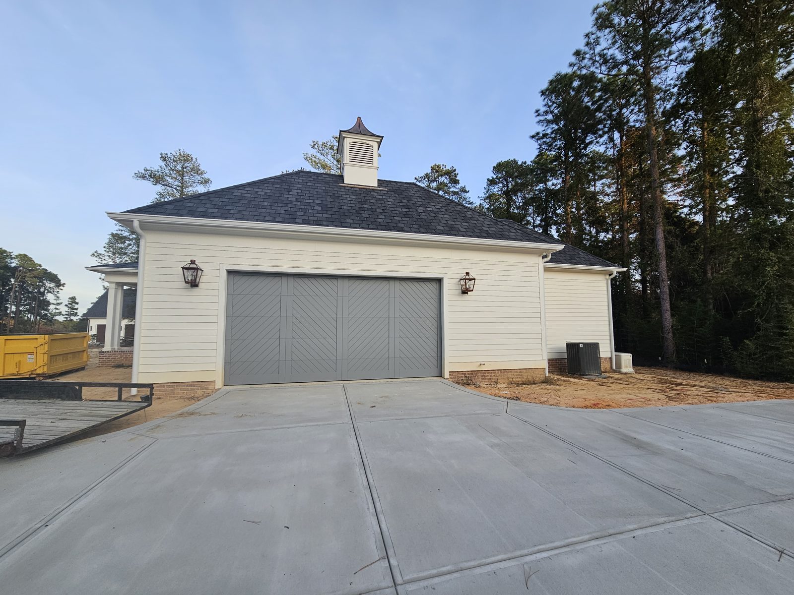 White garage doors on a detached building completed by Premier Access Solutions